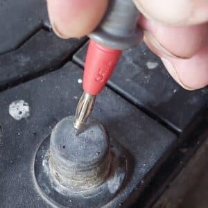 meter probe on battery terminal